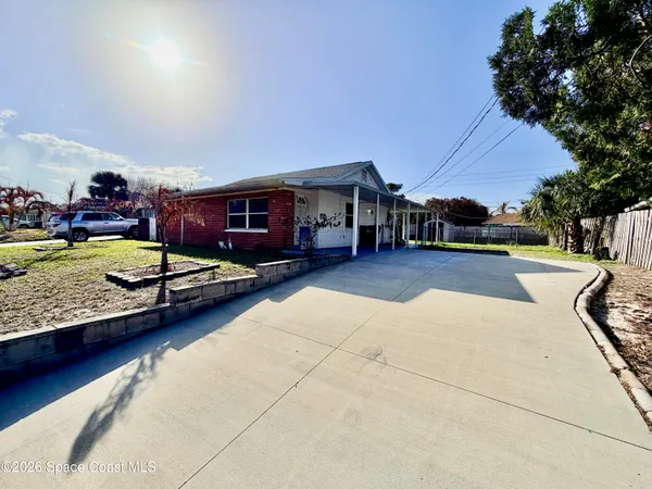 a view of a house with swimming pool and sitting area