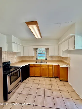 a kitchen with a sink and a stove top oven