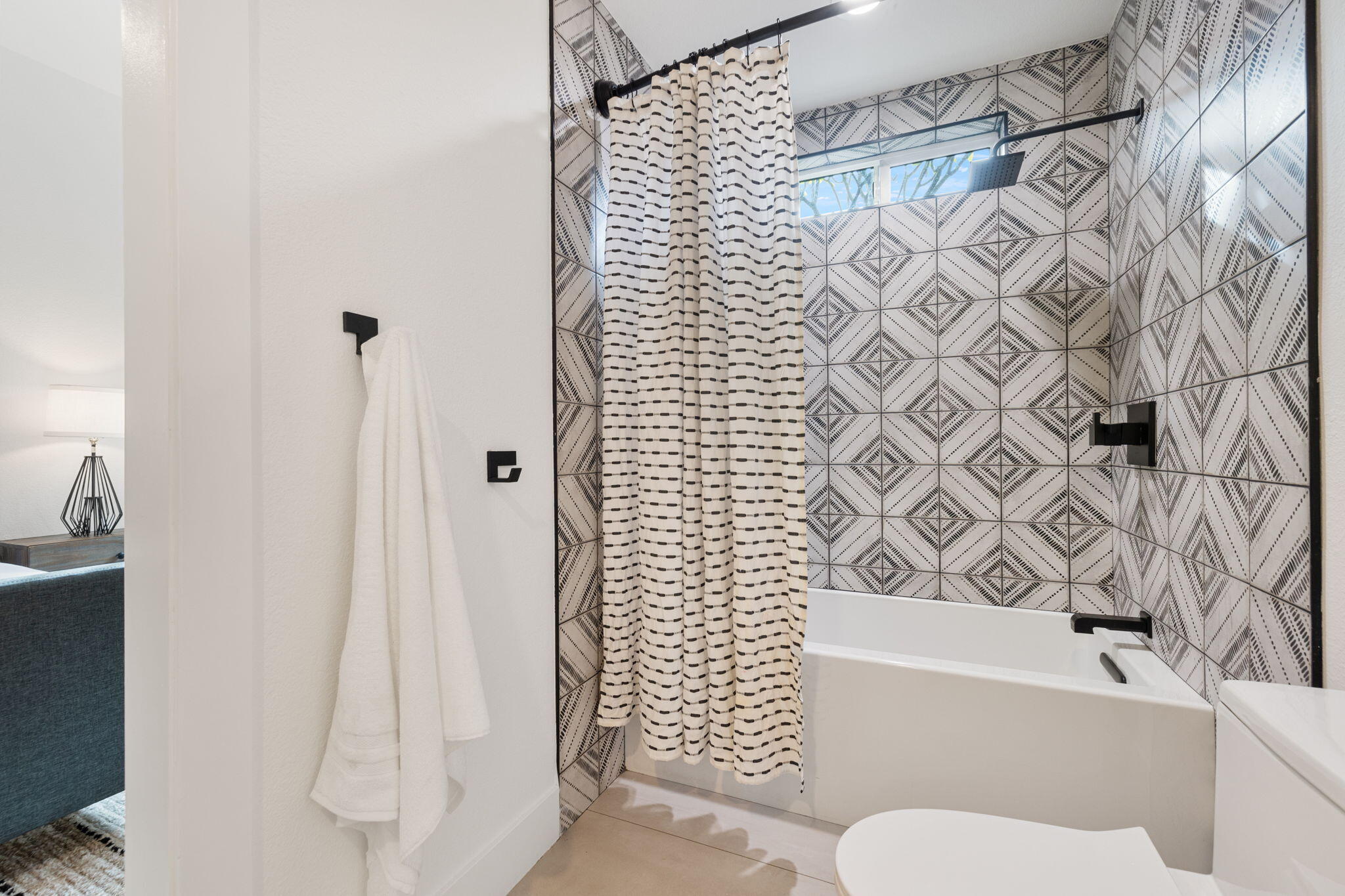 37011 Palmdale Road Rancho Mirage, CA 92270 - Photo 33 of 63 a bathroom with a toilet and a shower curtain