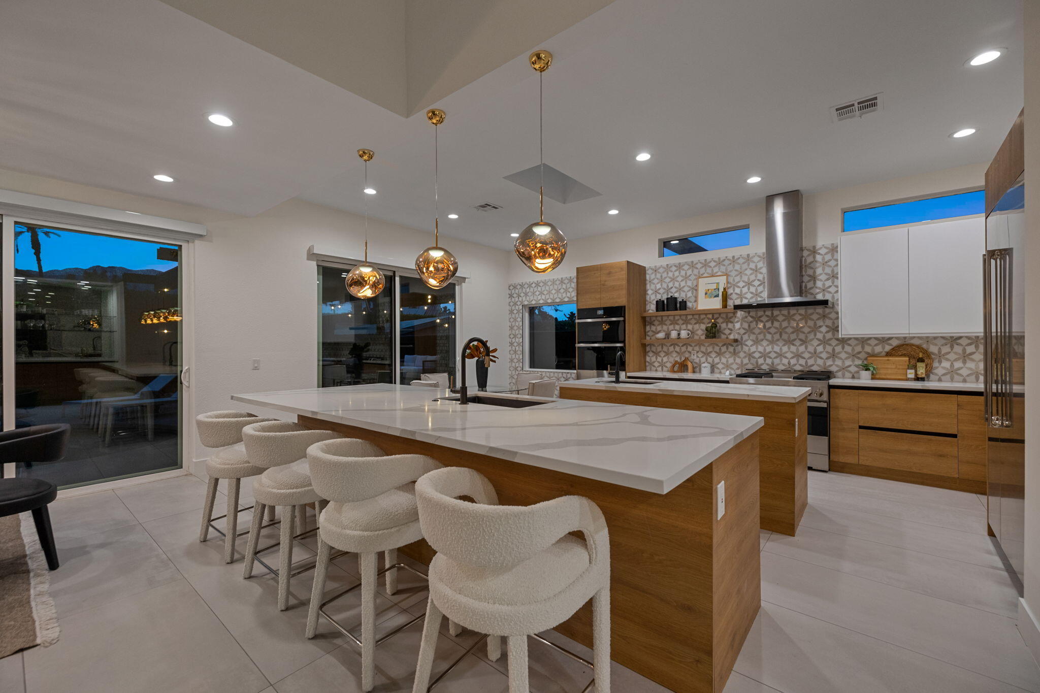 37011 Palmdale Road Rancho Mirage, CA 92270 - Photo 56 of 63 a kitchen with stainless steel appliances granite countertop table chairs sink and stove