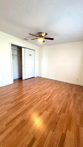 a view of empty room with wooden floor