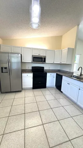 a kitchen with stainless steel appliances cabinets a sink and a counter top space
