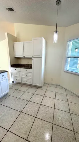 a kitchen with a stove a refrigerator and cabinets