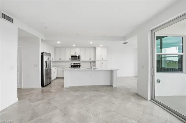 a kitchen with stainless steel appliances a refrigerator a stove a microwave and cabinets