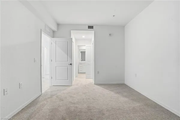 a bathroom with a granite countertop sink a mirror and a shower