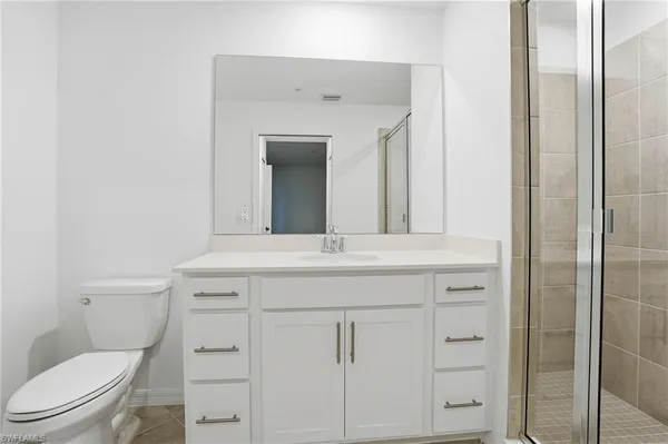 a bed room with a bed and a painting on the wall