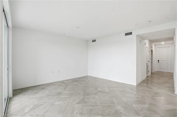 a view of an empty room and a window