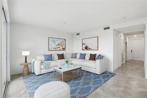 a living room with furniture and a painting