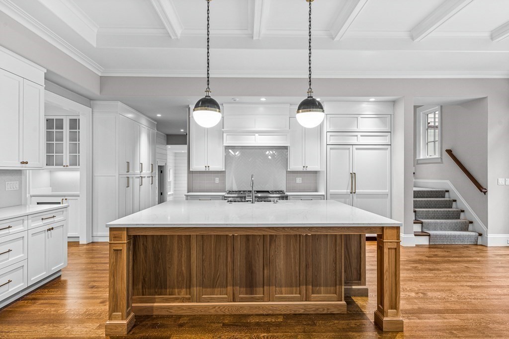 8 Lowell Road Wellesley, MA 02481 - Photo 5 of 16 a kitchen with kitchen island a counter top a stove a sink and a wooden floors