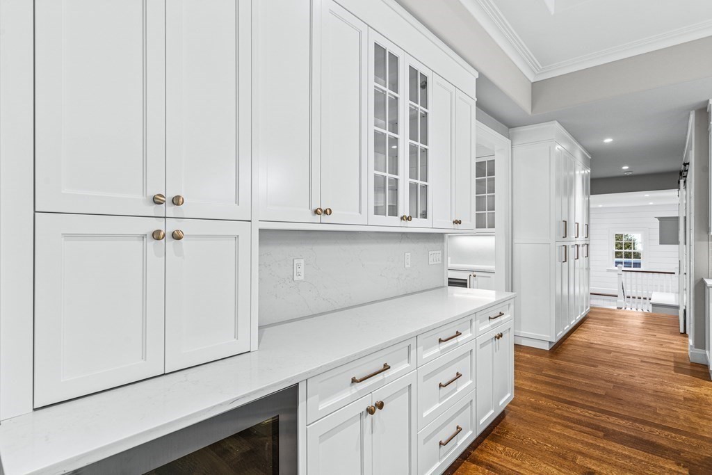 8 Lowell Road Wellesley, MA 02481 - Photo 8 of 16 a kitchen with stainless steel appliances white cabinets and wooden floors
