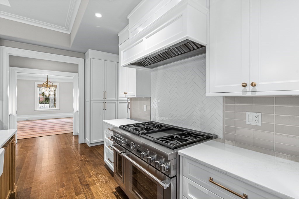 8 Lowell Road Wellesley, MA 02481 - Photo 9 of 16 a kitchen with granite countertop a stove and a refrigerator