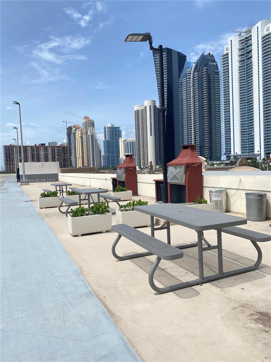 16919 North Bay Road, Unit 509 Sunny Isles Beach, FL 33160 - Photo 12 of 43 a living room with furniture a rug and a table