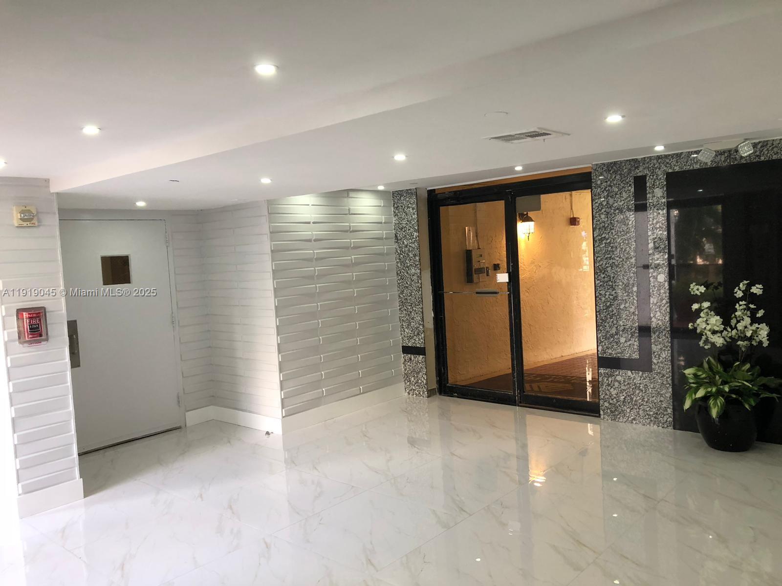 16919 North Bay Road, Unit 509 Sunny Isles Beach, FL 33160 - Photo 15 of 43 an empty room with closet and mirror