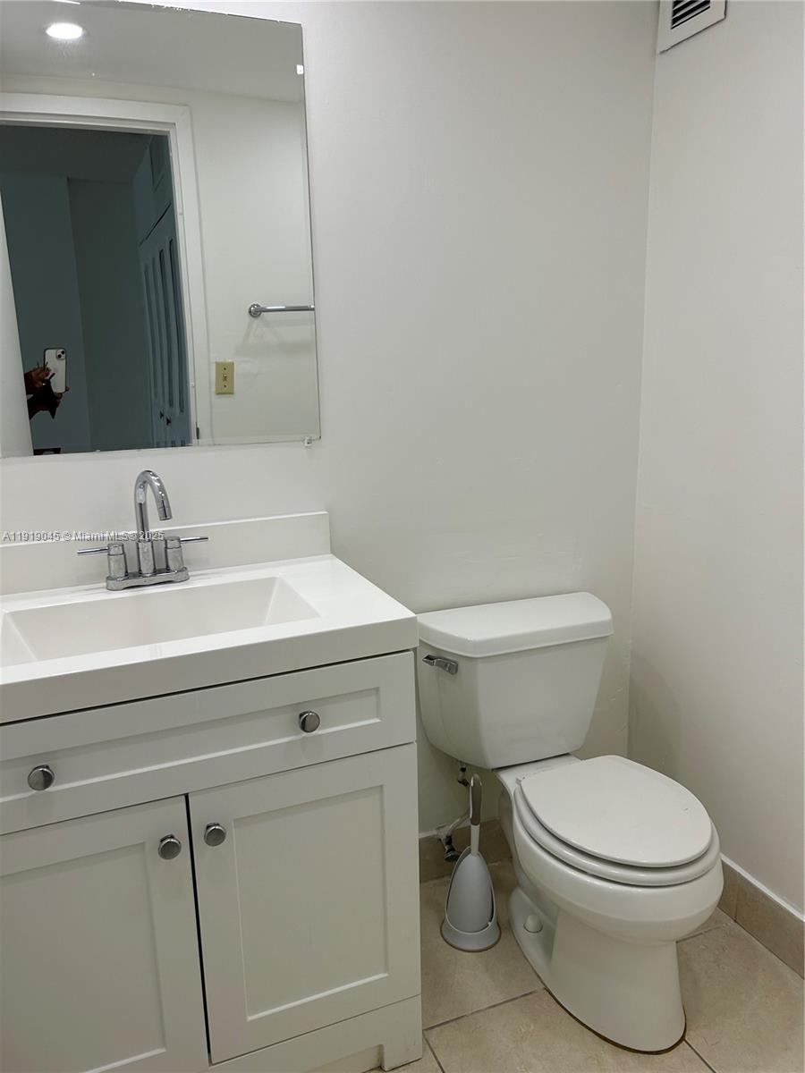 16919 North Bay Road, Unit 509 Sunny Isles Beach, FL 33160 - Photo 23 of 43 a bathroom with a sink a toilet and mirror