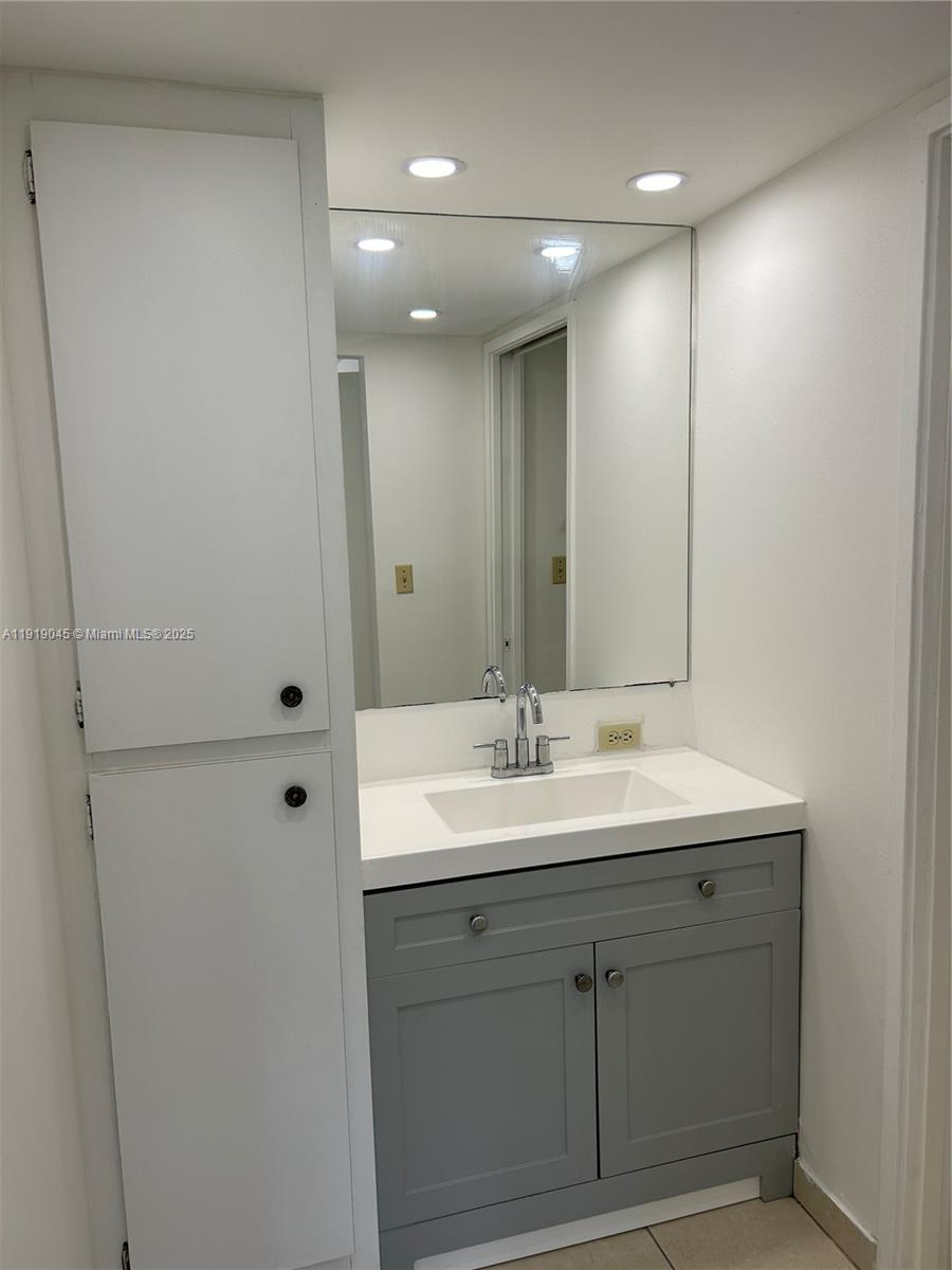 16919 North Bay Road, Unit 509 Sunny Isles Beach, FL 33160 - Photo 30 of 43 a bathroom with a double vanity sink and a mirror