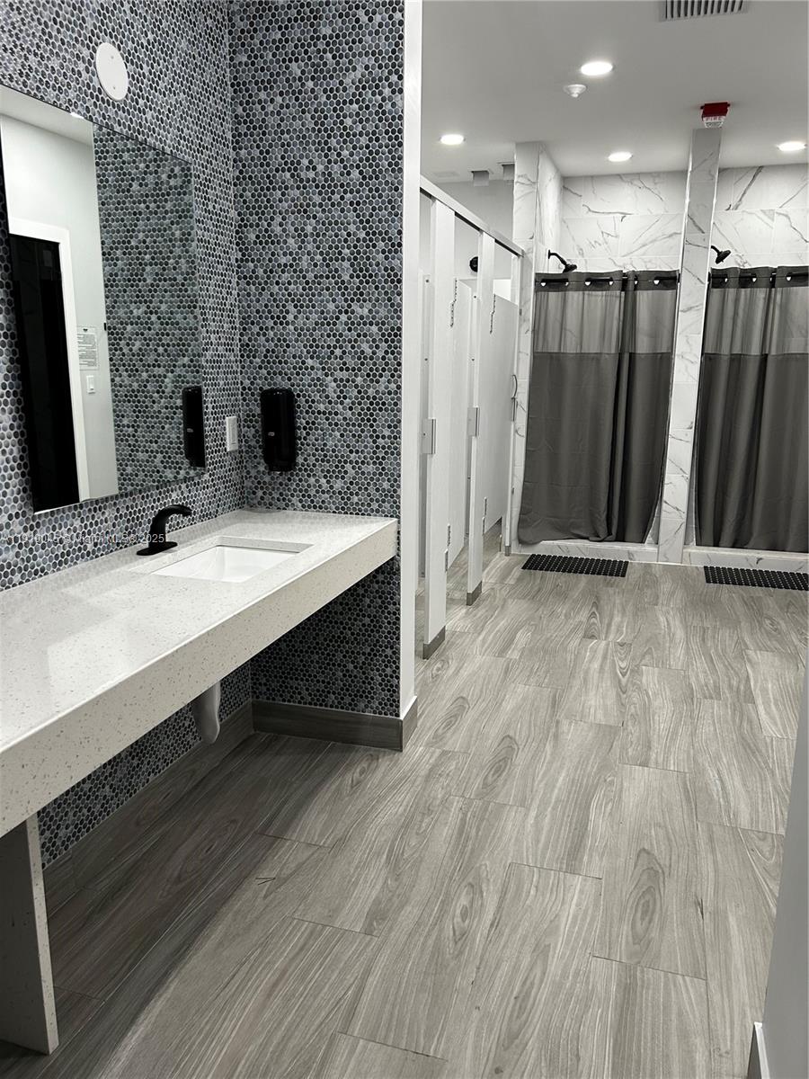 16919 North Bay Road, Unit 509 Sunny Isles Beach, FL 33160 - Photo 37 of 43 a bathroom with double vanity sink and a mirror