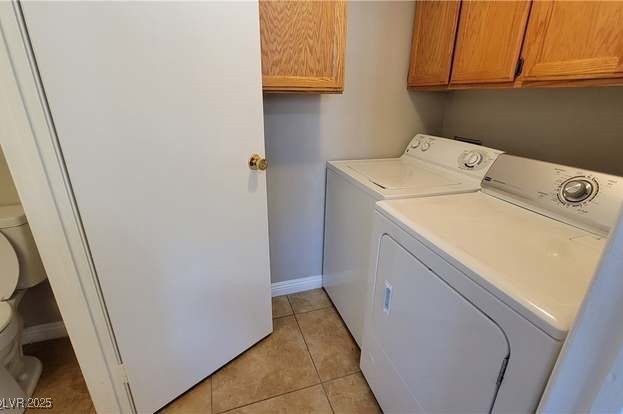 1016 Vantage Point Road Las Vegas, NV 89128 - Photo 13 of 18 Clothes washing area featuring light tile patterned floors, baseboards, cabinet space, and separate washer and dryer