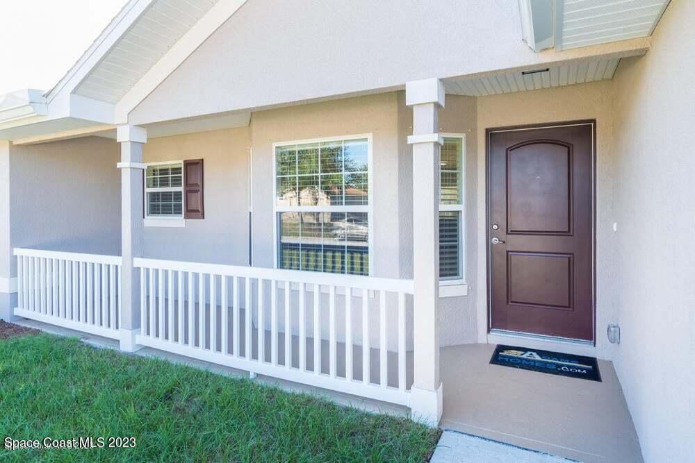 338 Garvey Road Palm Bay, FL 32908 - Photo 2 of 12 a view of a porch with wooden floor and a fireplace