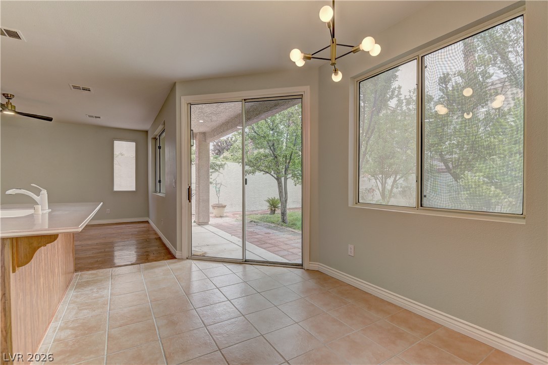 1813 Snow Spring Lane Las Vegas, NV 89134 - Photo 16 of 37 A well-lit dining area offers direct access to a private patio through sliding glass doors.