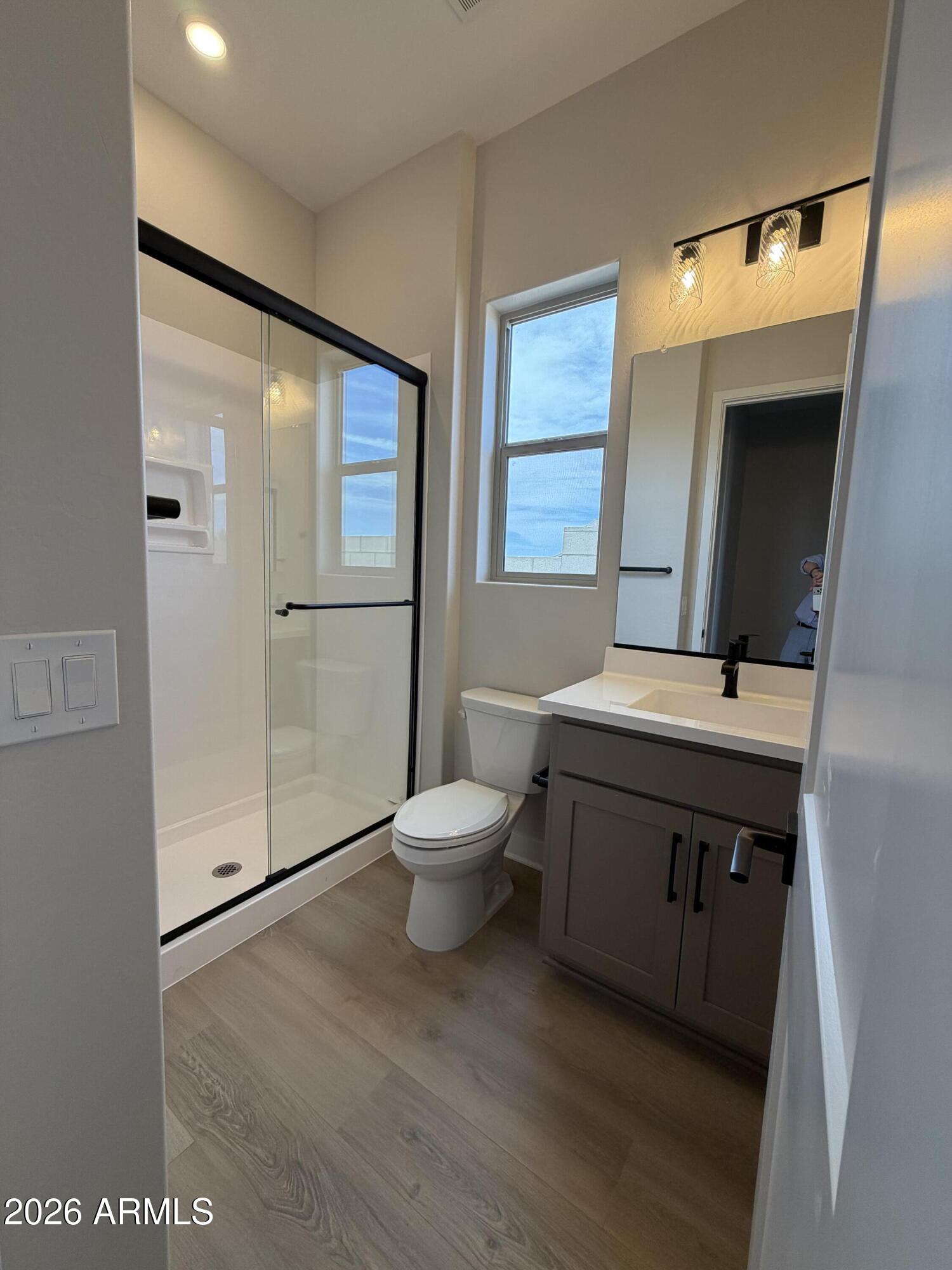 15767 West Sand Hills Road Surprise, AZ 85387 - Photo 19 of 60 a bathroom with a sink mirror and toilet