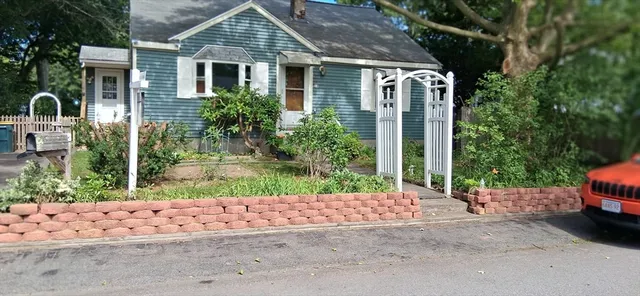 a front view of a house with garden