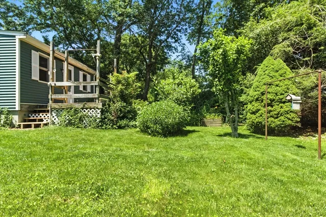 a view of a house with a backyard