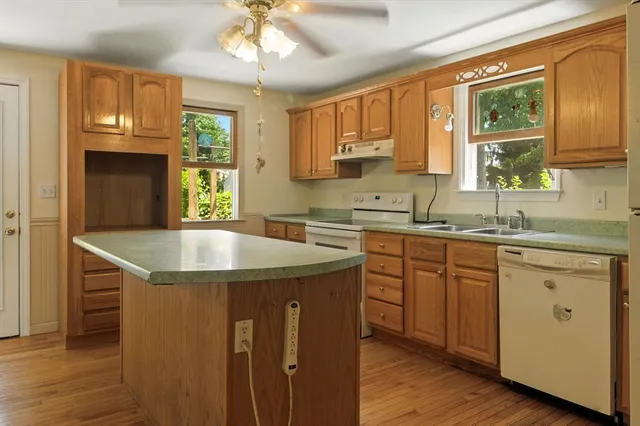 a kitchen with a sink stove and microwave