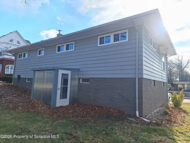 a view of a brick house with a yard