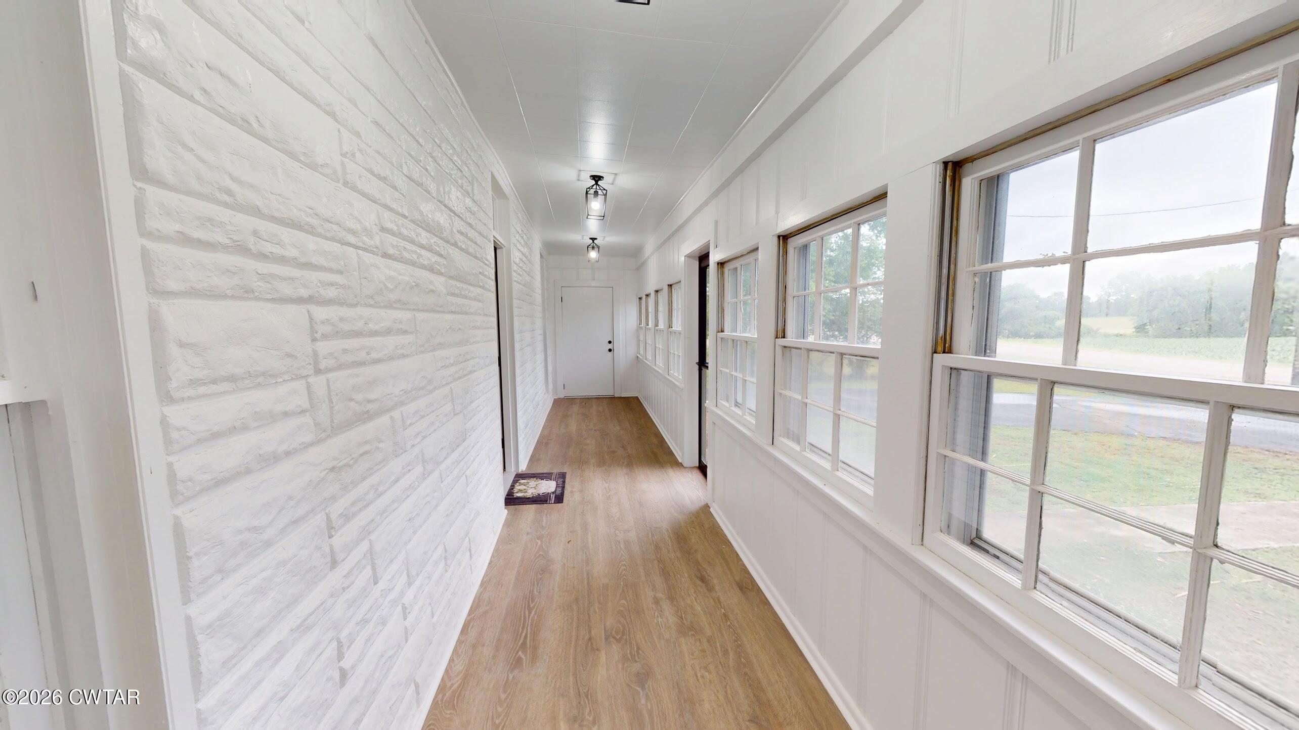 2800 Locust Grove Road Newbern, TN 38059 - Photo 5 of 46 a view of a hallway with wooden floor and chandelier