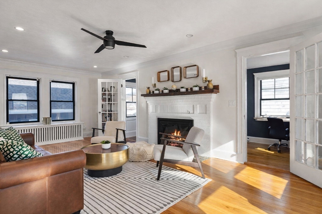 424 Brook Road Milton, MA 02186 - Photo 5 of 41 a living room with furniture a rug and a fireplace