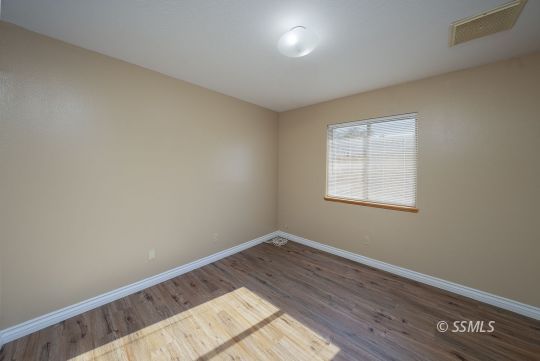 336 North Kern Street Ridgecrest, CA 93555 - Photo 16 of 35 an empty room with wooden floor and windows