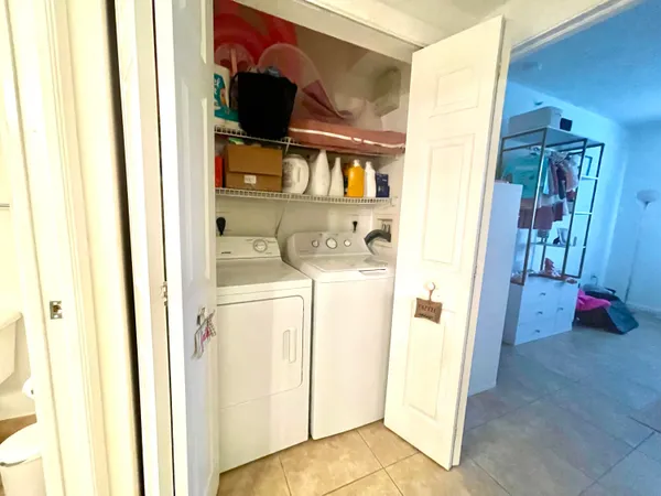 a view of walk in closet with clothes shoes