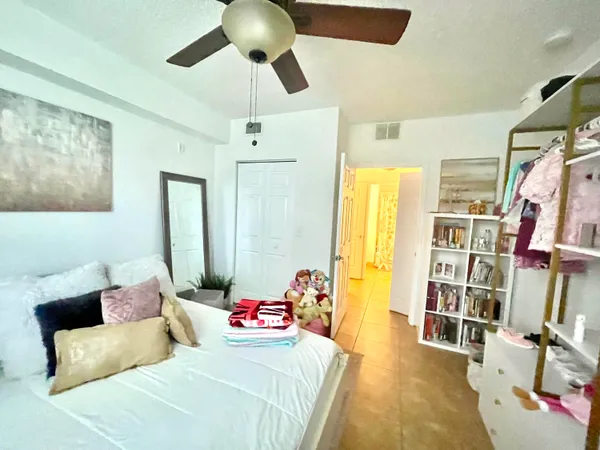 a bedroom with a bed furniture and a large window