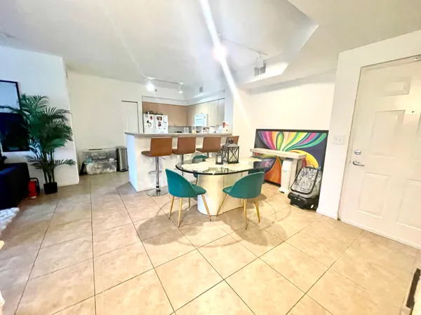a dining room with a table and chairs