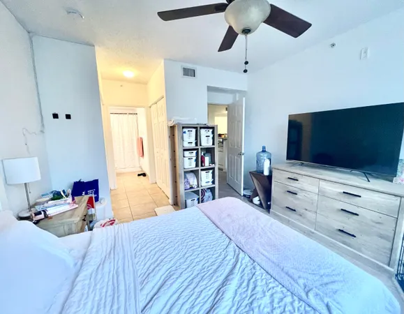 a bedroom with a bed and a flat screen tv