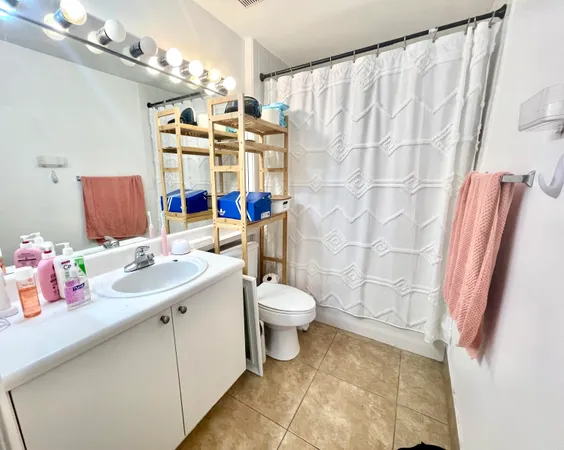 a bathroom with a sink toilet and shower