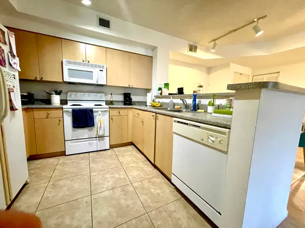 a kitchen with stainless steel appliances granite countertop a sink and cabinets