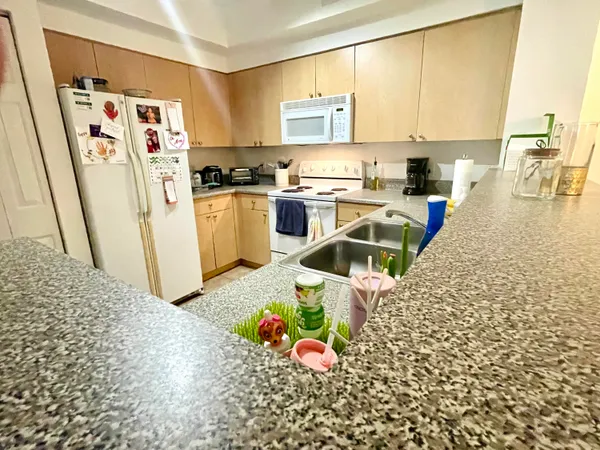 a kitchen with refrigerator and window