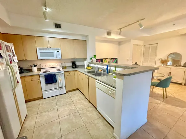 a kitchen with stainless steel appliances granite countertop a stove sink and cabinets