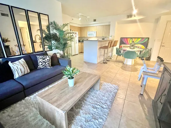 a living room with furniture and a large window