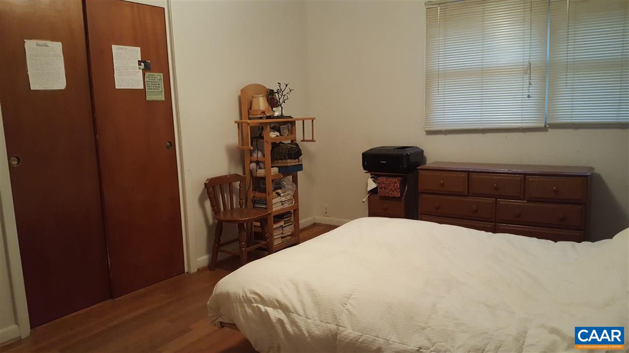 111 Apple Tree Road Charlottesville, VA 22903 - Photo 8 of 19 a bedroom with a bed and wooden floor