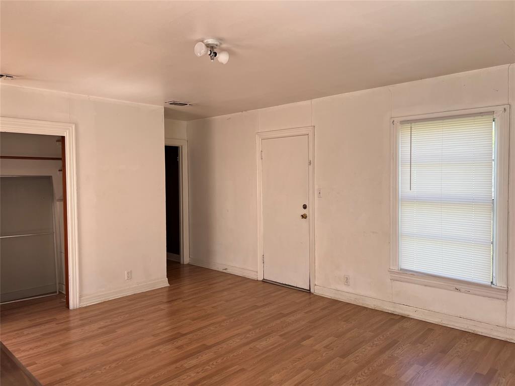 1401 Polk Street Wichita Falls, TX 76309 - Photo 12 of 29 a view of an empty room with wooden floor and closet