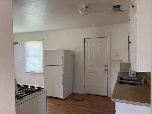 a kitchen with a refrigerator and a stove