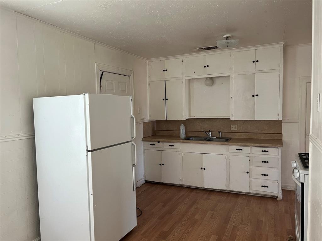 1401 Polk Street Wichita Falls, TX 76309 - Photo 2 of 29 a white refrigerator freezer sitting inside of a kitchen