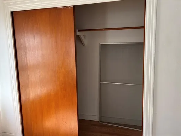 a view of walk in closet with wooden floor