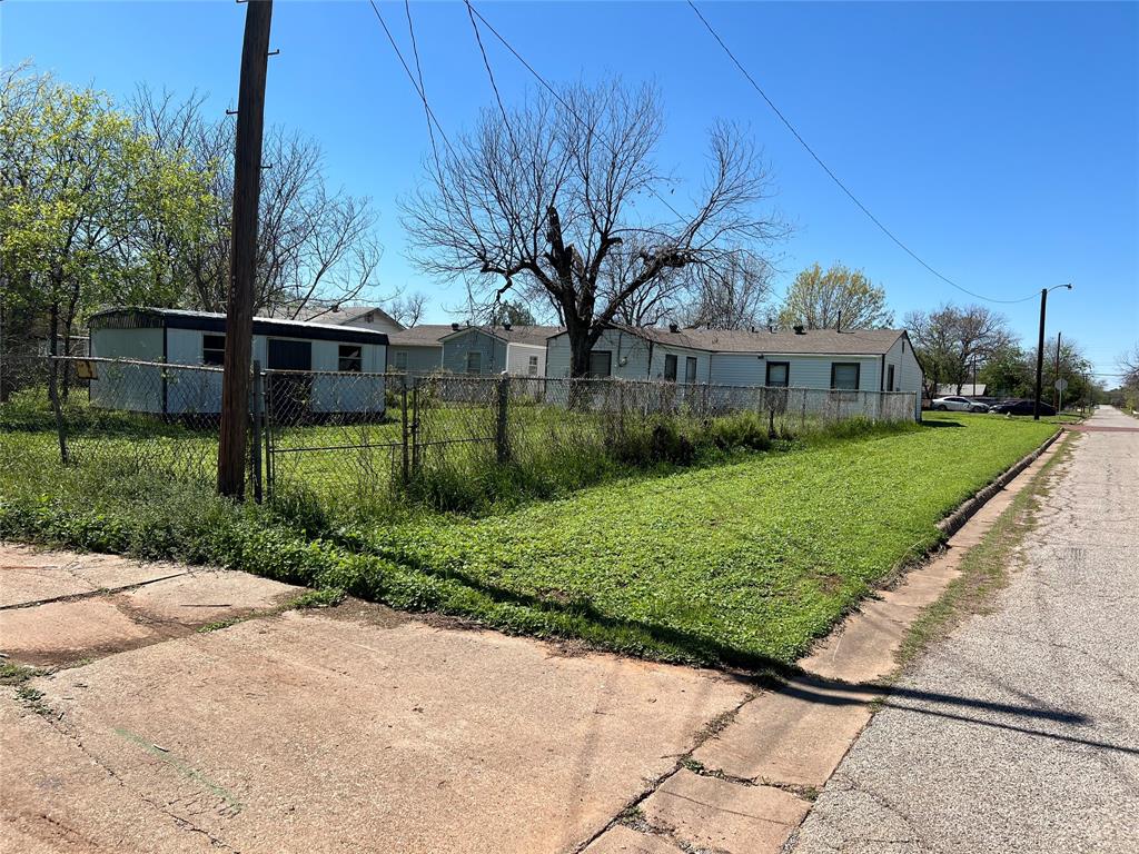 1401 Polk Street Wichita Falls, TX 76309 - Photo 3 of 29 a view of a white house next to a yard with big trees