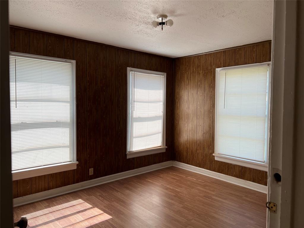 1401 Polk Street Wichita Falls, TX 76309 - Photo 4 of 29 a view of an empty room with wooden floor and a window