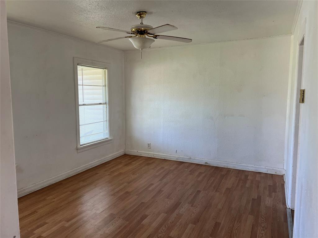 1401 Polk Street Wichita Falls, TX 76309 - Photo 9 of 29 wooden floor in an empty room with a window