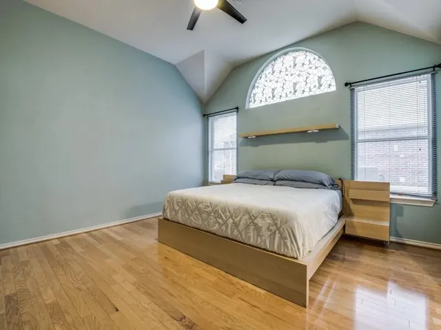 a bedroom with a large bed and a large window