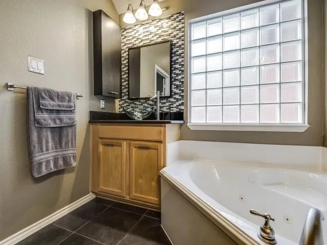 a bathroom with a bathtub and a sink